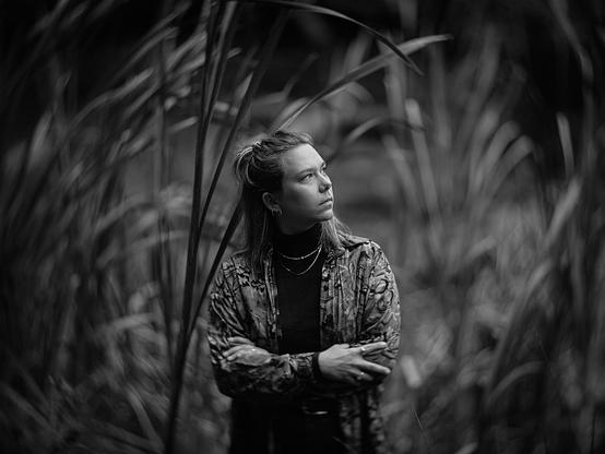 Portrait of a woman standing in larger-than-life reeds
