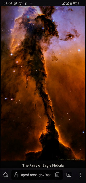 The image displays a stunning view of the Eagle Nebula, specifically known as the "Fairy of Eagle Nebula." The central feature is a towering pillar of gas and dust, illuminated by the light from nearby stars, creating a striking contrast of dark and bright areas. The colors range from deep oranges and browns to purples and blues, highlighting the nebula's intricate structure. Numerous stars are visible in the background, adding to the cosmic scene. The image is credited to NASA, ESA, The Hubble Heritage Team, and STScI/AURA, as indicated at the bottom. The interface suggests this is a screenshot from a mobile device, with a status bar showing the time, network, and battery level.

 Ovis2-8B

🌱 Energy used: 0.208 Wh
