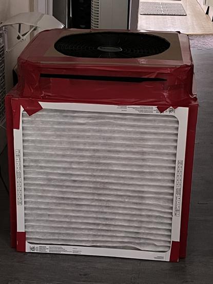 A Corsican-Rosenthal air scrubber, white filters, black fan, red duck tape.