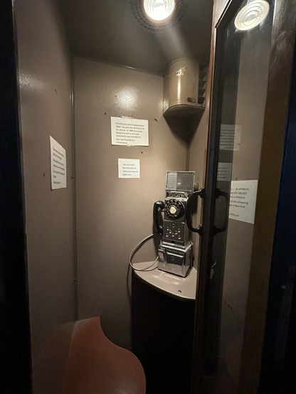 Old rotary dial payphone booth interior