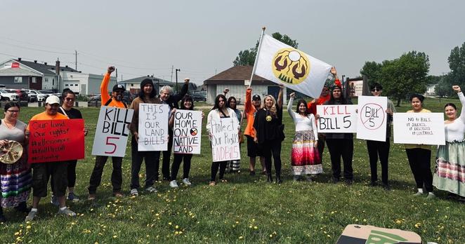 Youth Led Protest Against Bill 5 participants were supported by First Nation and local leaders. Pictured are protest participants and Chief Jennifer Constant, Mattagami FN, in the centre under the flag of Mattagami FN.