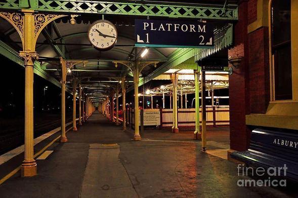 This is the very long and beautiful undercover platform at Albury Station, Victoria, Australia. I believe it is the longest undercover platform in the Southern Hemisphere. The Italian design and architecture make this a worthwhile visit and a walk along the long platform to view its Victorian design. I also have a photo of the front of the Albury Station building in my gallery "Buildings".
THE FINE ART AMERICA LOGO WILL NOT APPEAR ON PURCHASED PRINTS OR PRODUCTS.

By Kaye Menner Photography
https://kaye-menner.pixels.com/featured/beautiful-old-albury-station-by-kaye-menner-kaye-menner.html

[From Wikipedia]
Albury railway station is located on the New South Wales/Victorian border city of Albury. Designed and constructed under the supervision of John Whitton, it opened on 26 February 1882, replacing a temporary structure, which opened on 3 February 1881, when the Main South line was extended from Gerogery.