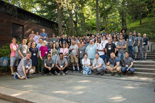 Large group photo of GBCC2025 attendees outdoors at Cold Spring Harbor Laboratory, smiling and gathered on the steps.