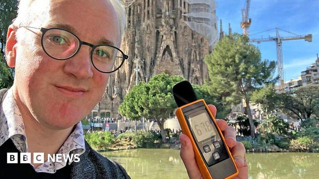 James Gallagher holding a sound meter 