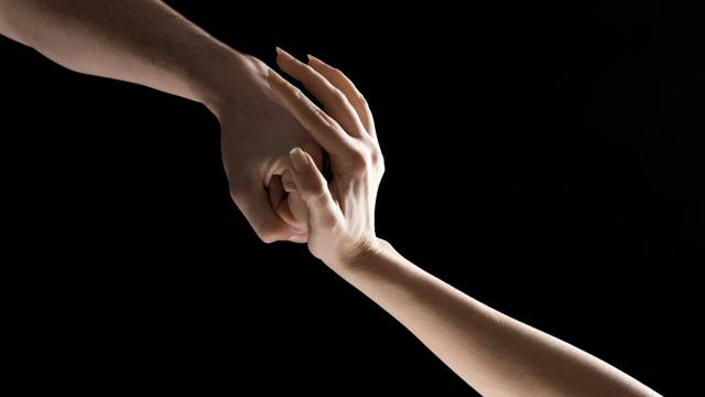 Image of a hand stopping a fist.