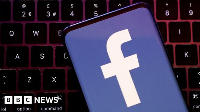 A phone screen showing a Facebook logo against a QWERTY keyboard