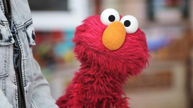 Pictured: Elmo from Sesame Street looking surprised at the viewer