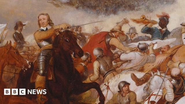 A close-up of a portrait of the Battle of Naseby. Oliver Cromwell is shown on a rearing horse, wearing armour over a yellow jacket. A melee of men can be seen fighting one anther behind him and to his left. 