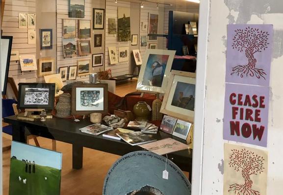 inside the pop up gallery with lots of craft work, photographs paintings etc