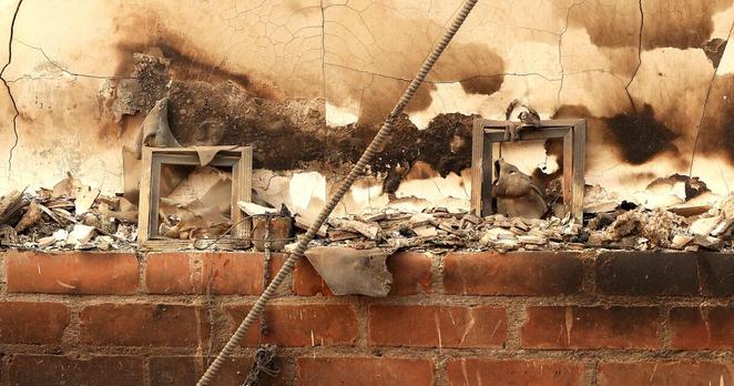 ALTADENA, CA, JANUARY 9, 2025: Picture frames atop the family's mantle at the home of William Harris, 63, that was burned down by the Eaton Fire in Altadena on Thursday, January 9, 2025. (Christina House / Los Angeles Times)