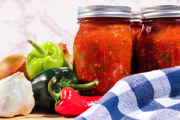 homemade salsa jars with fresh peppers and onions