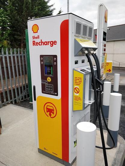 A large electrc charger with the Shell logo on it.