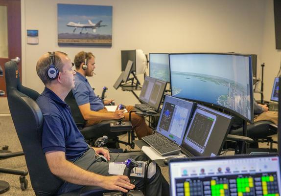 Andy Burroughs (left) and Paul Friz in the roles of air taxi pilots running through air taxi integration simulations focusing on urban air space at NASA’s Langley Research in Hampton, Virginia on Sept. 25, 2024.