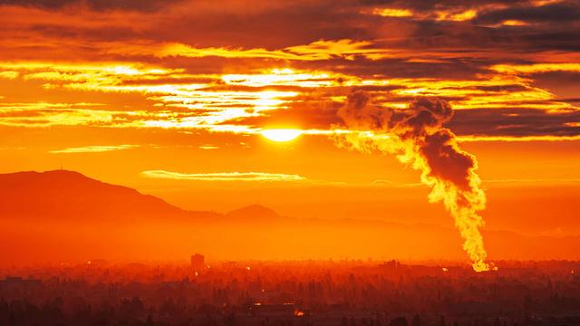 Industrial steam billowing into a glowing sunrise above the San Fernando Valley in Los Angeles California.