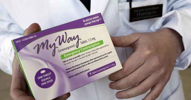 In this May 2, 2013 photo, pharmacist Simon Gorelikov holds a generic emergency contraceptive, also called the morning-after pill, at the Health First Pharmacy in Boston. (AP Photo/Elise Amendola, File)