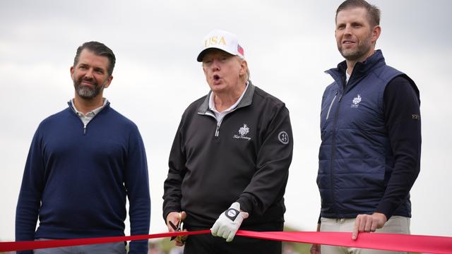 BALMEDIE, SCOTLAND - JULY 29:  U.S. President Donald Trump speaks next to Donald Trump Jr. (L) and Eric Trump as they attend the ribbon-cutting ceremony at a new 18-hole course at Trump International Golf Links on July 29, 2025 in Balmedie, near Aberdeen, Scotland. President Trump is visiting Scotland in a trip that’s part-vacation, part-work, as he stayed at his Trump Turnberry golf course, followed by Trump International Golf Links in Aberdeenshire, between July 25 to 29.  (Photo by Andrew Harnik/Getty Images)
