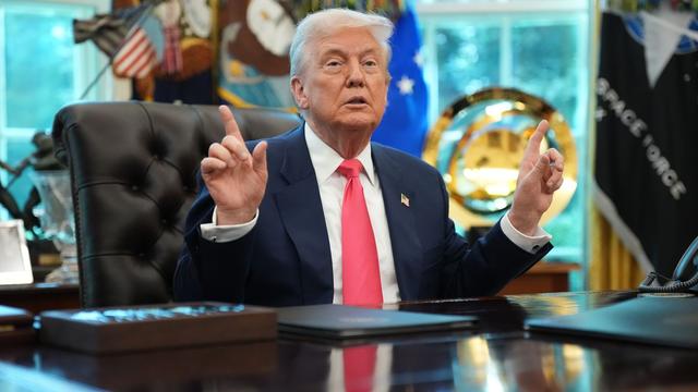 Trump points with both hands as he speaks in the Oval Office.