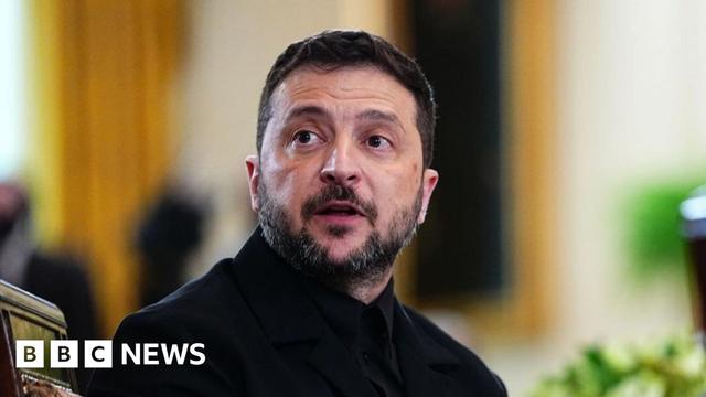 Ukrainian President Volodymr Zelensky, wearing a black suit, attends a meeting in Washington.