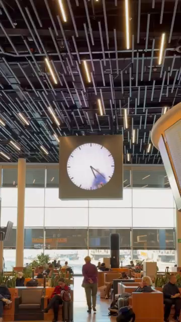 Large clock shows a video of a man trapped inside it, he’s perpetually rubbing off the minute hand and redrawing it in its new position.