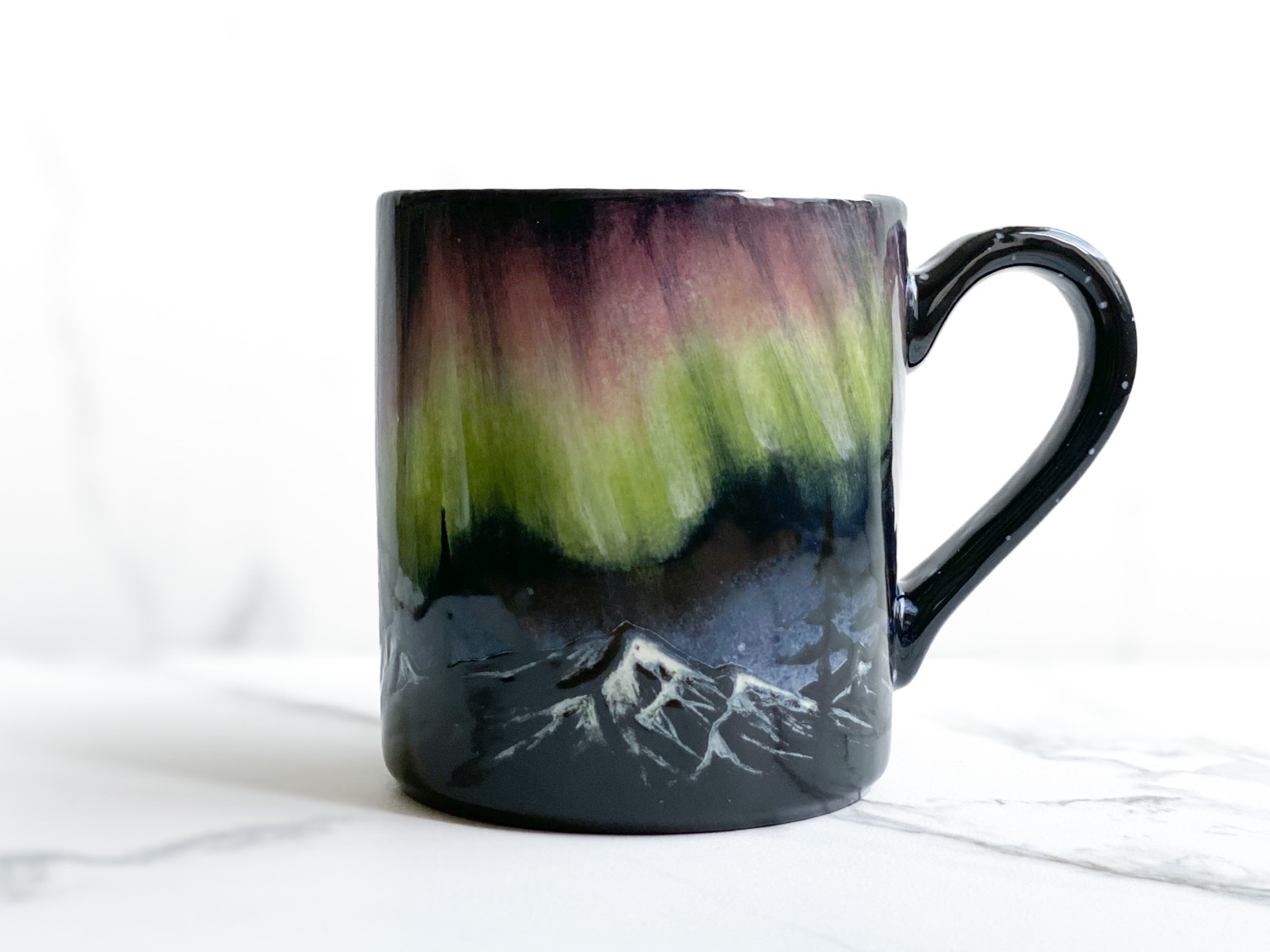 Mug featuring aurora over mountains
