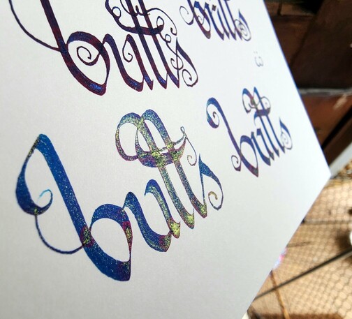 Angled view showing the shimmer and sheen in the ink; the closest butts now looks blue with a bright gold shimmer and slight purple sheen