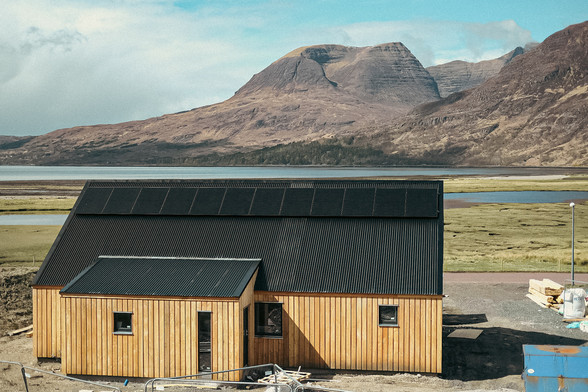 A colour photo of our house build in Annat, with Beinn Alligin and a bit of Liathach in the distance, above Upper Loch Torridon. Torridon, Wester Ross, Scottish Highlands.

Photo by and copyright of Lynn Henni. 