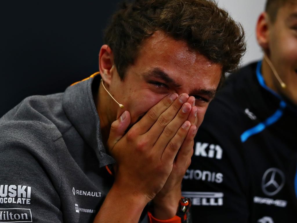 Photo of Lando Norris covering his mouth laughing during the 2019 British GP press conference.