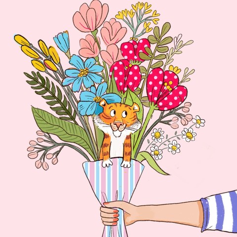 A small tiger sits in a colourful bouquet of flowers