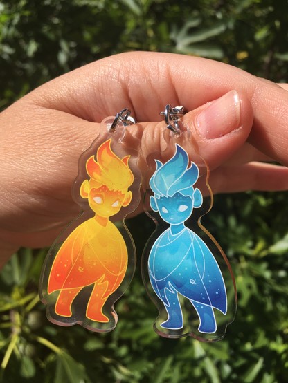 Fire creature acrylic keychains, orange and blue, by zizudraws