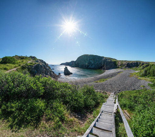 A view of Spiller's Cove near Twillingate, Newfoundland from the top of a large staircase leading down to the rocky beach. 