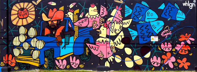 Murals of Islandview - Tony Whelgn
Bright and colorful abstract representation of a farm-like event. Pink and yellow chickens laying eggs, blue fish following a hooked worm, a field of pink flowers, the sun beaming and a farmer driving a blue truck with many headlights.