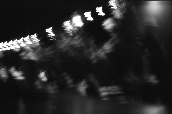 but don't let go of soft focus while approaching your destination

a blurry black and white photo of a sequence of light streaked knots, some shapes of living things beneath