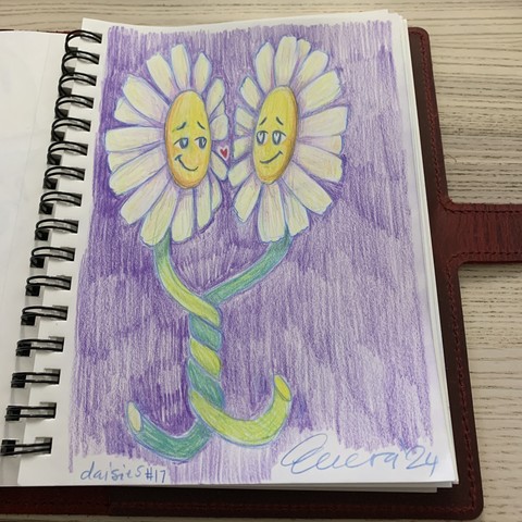sketchbook in red leather case on pale wooden surface. sketch in colored pencil of two white daisies with their stems wrapped around each other. the two daisies are smiling with hearts in their eyes and a small heart between them. bold signature, date, and 