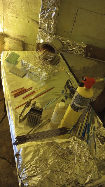 Photo from inside my new studio space, showing my work table, torch, glass warmer, various tools, etc.