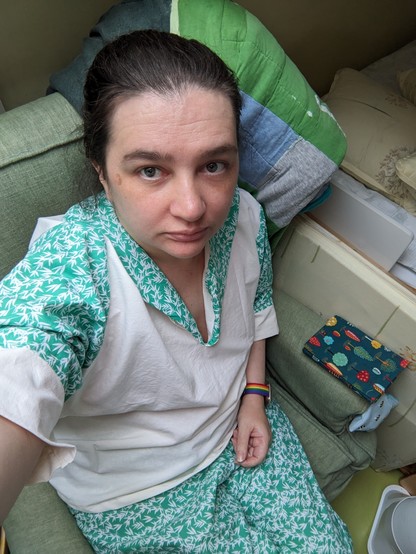 Selfie of me in short-sleeved pyjamas - green pattern for trousers, collar, and sleeves, and plain off-white for bodice and cuffs.