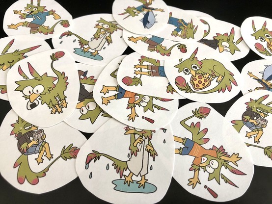 Photo of a lot of hand-cut stickers of a green anthro bird doing various stuff.