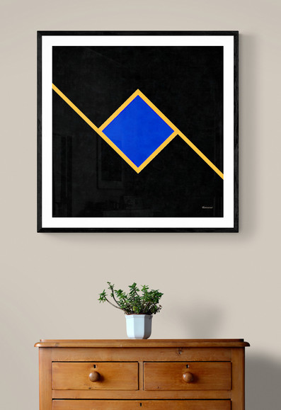 Shown framed and on a wall, this is No. 523, from contemporary artist/photographer Jon Woodhams. In a square format, against a black background, a diagonal line cuts across the canvas, with a blue diamond in the center, surrounded by a yellow frame.