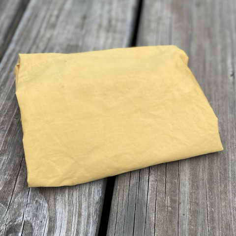 A folded piece of golden yellow cotton fabric 