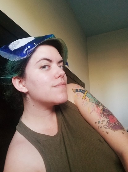 Messy photo of me slouching in bed with an ice pack sitting atop my head.