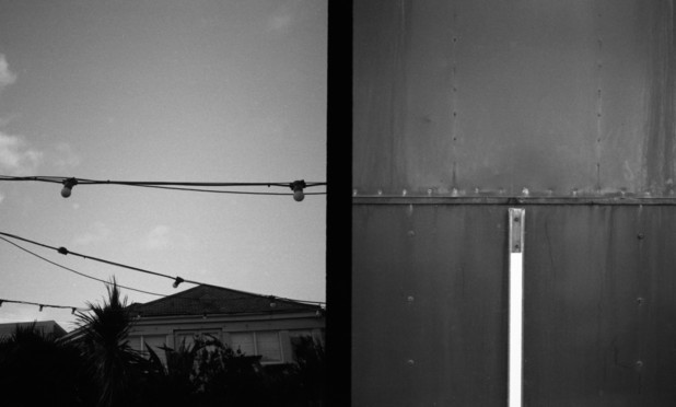 Diptych on black and white film. On the left a string of festoon lights, on the right details from a riveted metal coffee kiosk. Horizontal elements align in the middle of the frame.