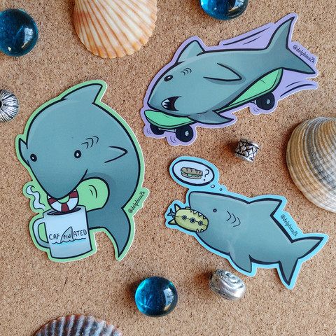 Stickers of sharks drinking coffee, skateboarding, and eating a submarine
