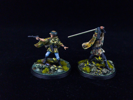 Luke and Leia minis for Star Wars Shatterpoint, both wearing Endor camo ponchos and on jungle foliage bases.