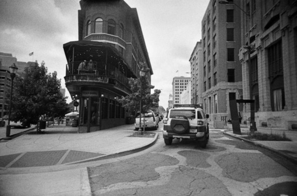 Black and white image featuring a wedge-shaped building in downtown Chattanooga, TN. Occupying the narrow end is the Pickle Barrel restaurant.