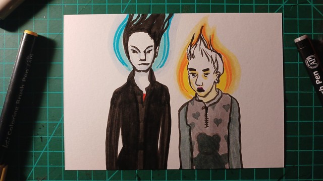 Coloured pen drawing of two people with glowing flame like haloes. Their hair is standing straight up. One has dark hair and dark clothes, the other has fair hair and wears a top patterned with a bear and hearts. 