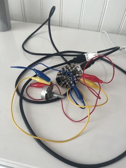 A mess of alligator clips hooked up to a potentiometer and a microcontroller