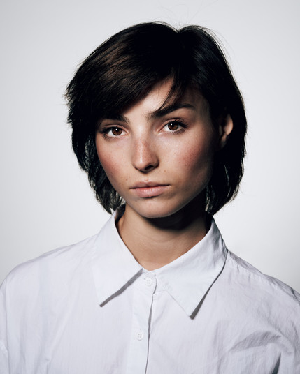 woman in a white shirt against a white background
