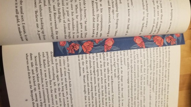 Photo of a thin bookmark covered in red flowers.