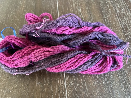 After 1: Thr Cochineal

Dark and light skeins of yarn are twisted together to form a SuperSkein on a dark wood table. The lighter color is a raspberry red - a blue-red, really. The dark is a deep grape purple.