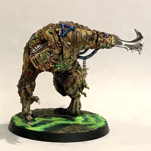 Large rat-man-monster in dark greens and browns. Its flesh is tearing away showing grotesque green-tinged skin and muscle. It has brass armor and weapons grafted to it. It walks over broken ground with green glowing waves in puddles. 