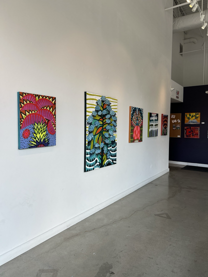 Photo of art exhibit featuring colorful graphic paintings